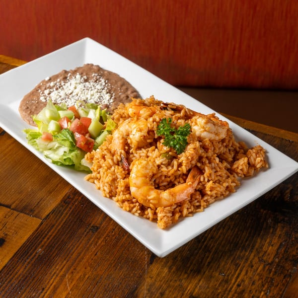 Frida's Mexican Grill's shrimp and rice dish with refried beans and a side salad.